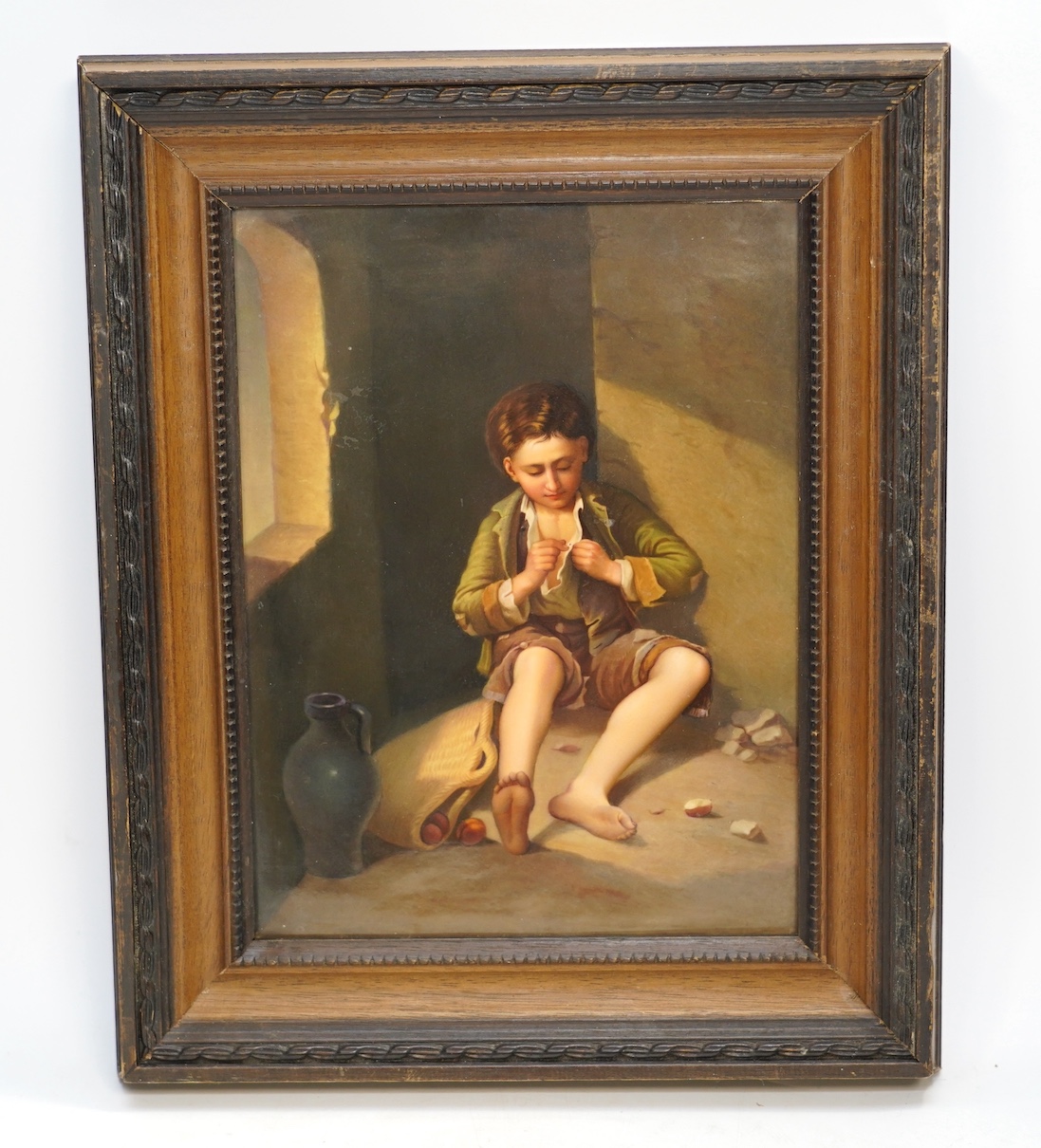 A KPM Berlin porcelain plaque, painted with a young beggar after Murillo, 18.5cm wide, 25cm high. Condition - good